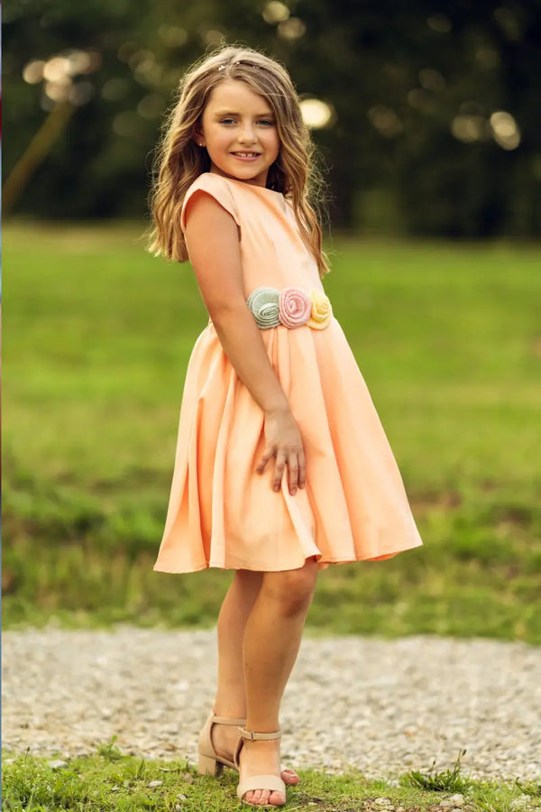 Elegant salmon pink girls dress with floral details and flower belt, perfect for special occasions and formal events | Yotty Boutik