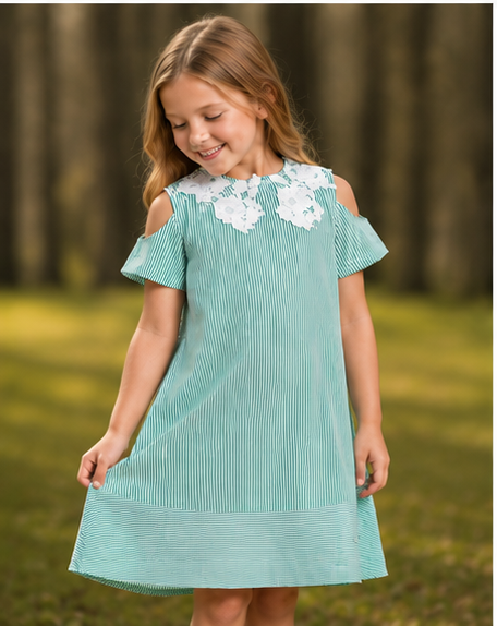 Girl wearing a stylish green striped dress with white lace detailing, enjoying the outdoors. verdant lace a-line dress